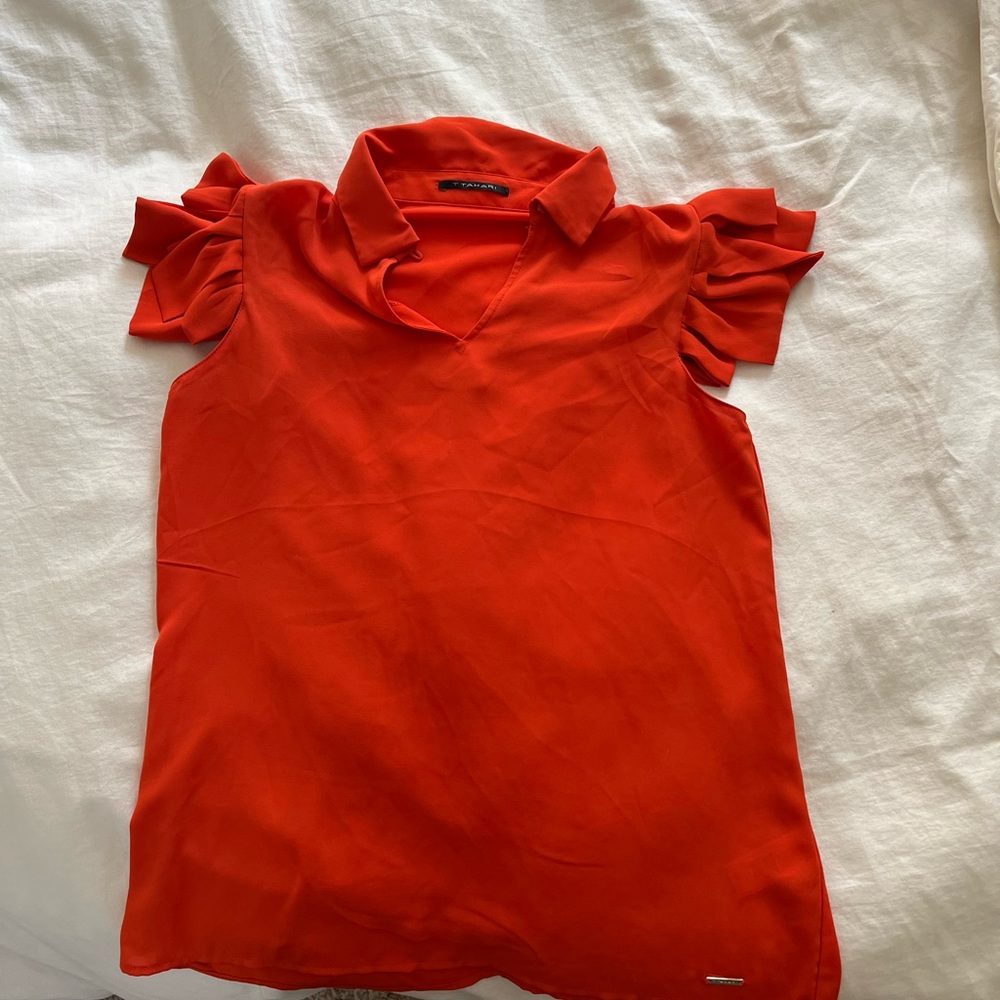 T Tahari orange blouse with short fringe sleeves. Collared neck with button.